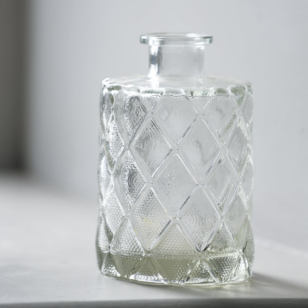 small clear glass bud vase with diamond detail on base