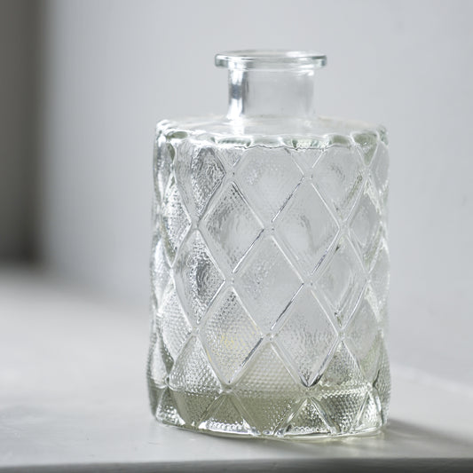 small clear glass bud vase with diamond detail on base