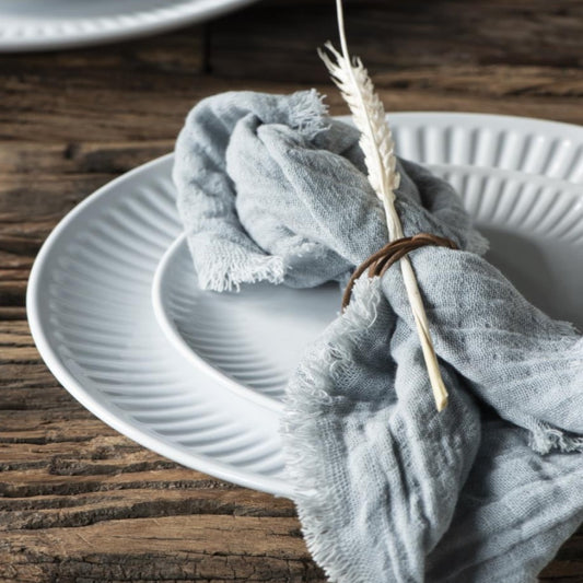 beautiful light blue fringed napkin made from linen and cotton blend