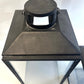 Black metal lantern on a white background