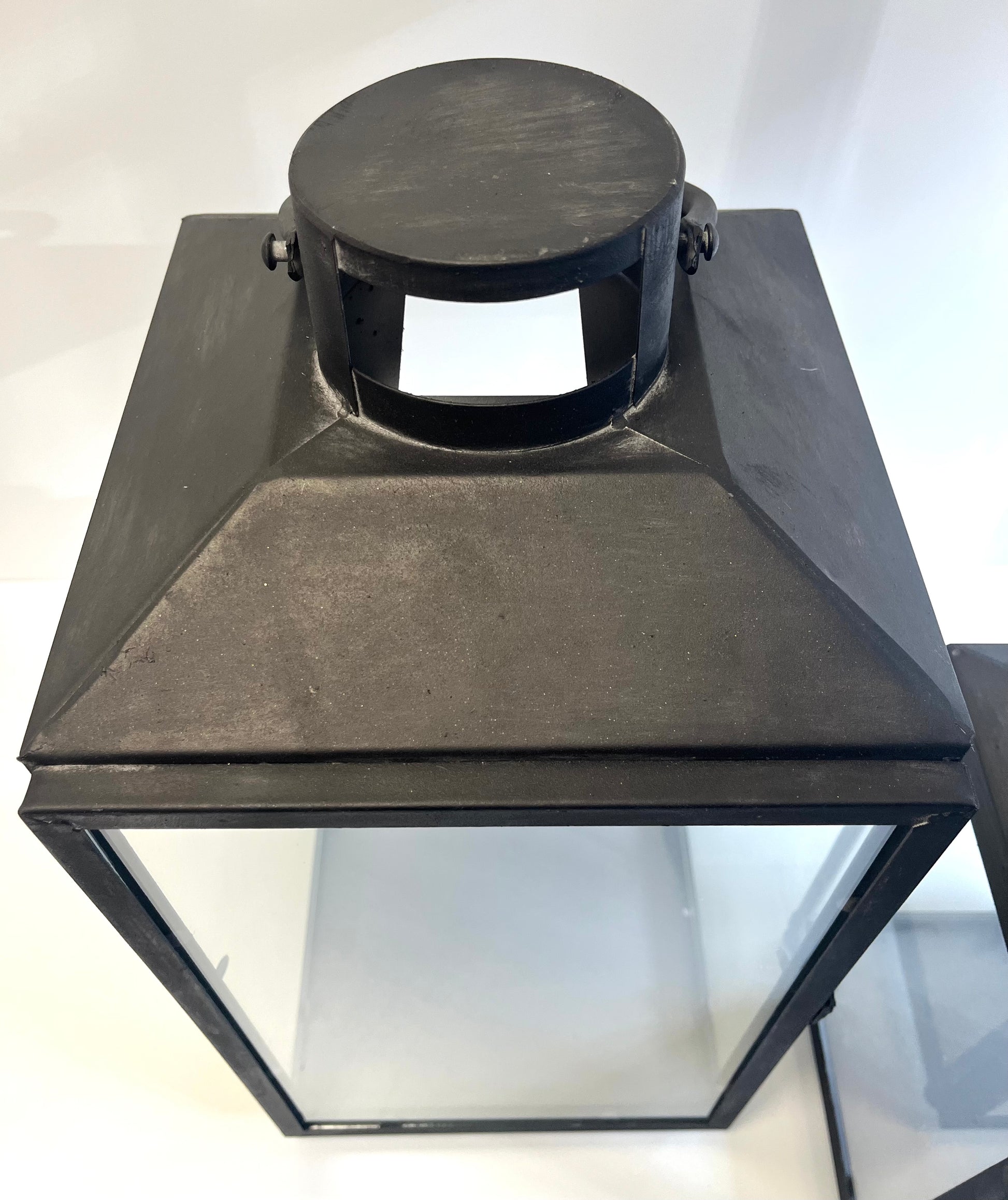 Black metal lantern on a white background