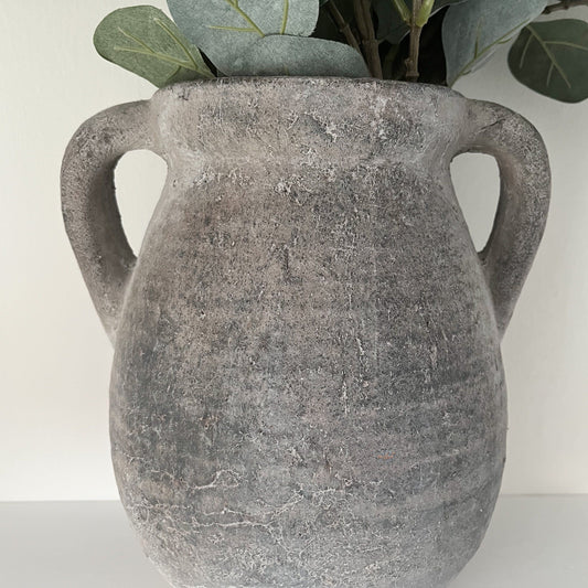 rustic stone-effect vase with chunky handles, styled with faux eucalyptus