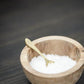 brass salt spoon in wood pinch pot