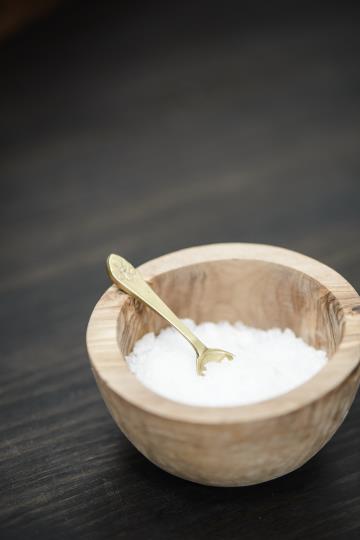 brass salt spoon in wood pinch pot