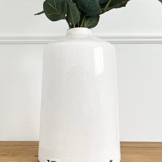 tall ivory glazed ceramic vase with distressed look and slight crackle effect on base.