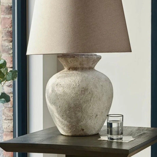 large neutral stone base table lamp with linen shade