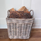 side view of square rattan basket with basket displaying logs