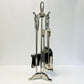 Set of silver fireplace tools on a white background