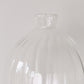 Tall ribbed glass vase perfect for displaying blooms or stems