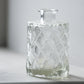 small clear glass bud vase with diamond detail on base