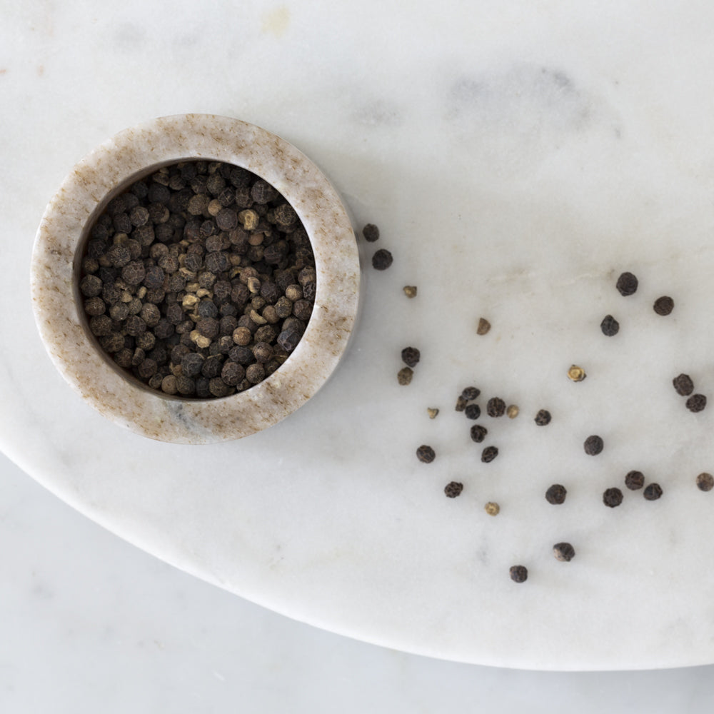 A stunning marble salt/pepper cellar used in the kitchen as a handy tool for seasoning meals